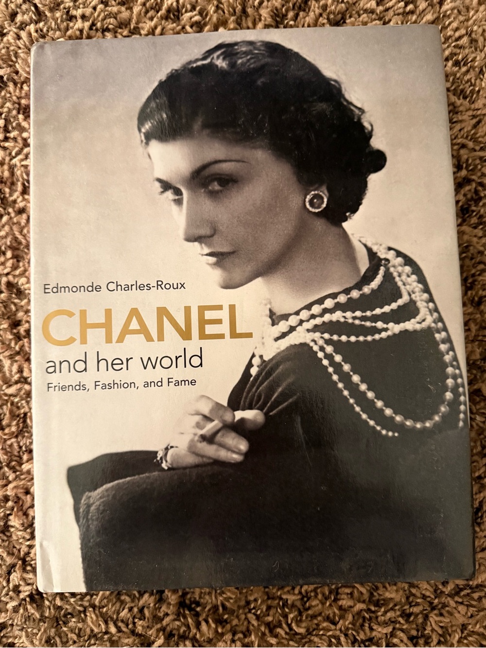 CHANEL Hardcover Book with Gold Illustration on Cream Cover